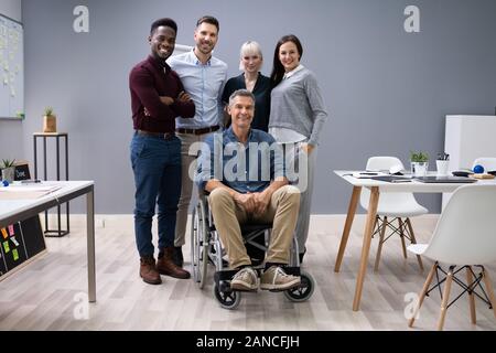Group Of Happy Multiracial Businesspeople Standing In Office Stock Photo