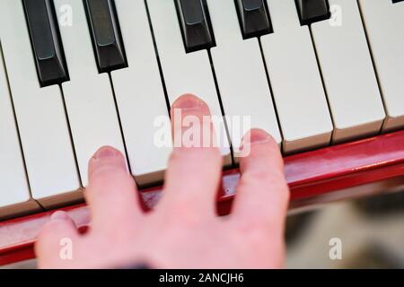 Hands on the piano. Concept games on the music instrument. Close up. Stock Photo