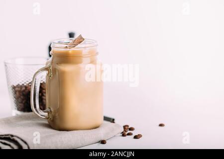 Iced coffee in jar, mug glass cup on the white table Stock Photo - Alamy