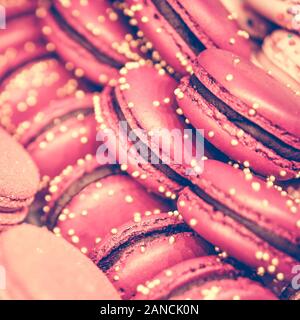Delicious and beautiful pink macaroons on sale. Close up. square format, toned Stock Photo