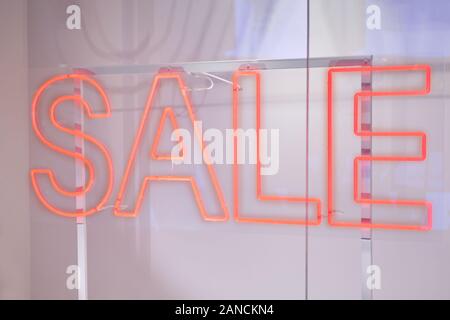 Neon red sign sale on storefront. Close up. Stock Photo