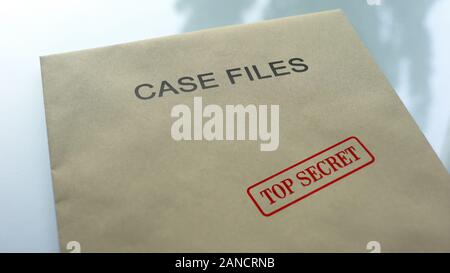 Case files top secret, seal stamped on folder with important documents, close up Stock Photo