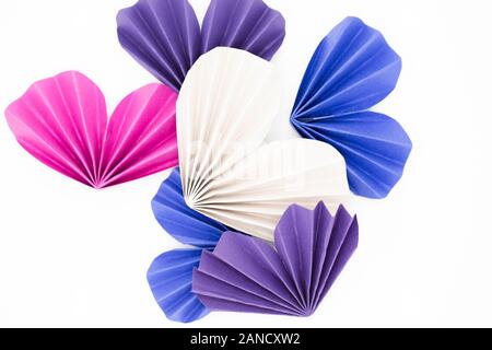 Origami hearts of various colors against white background Stock Photo