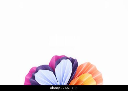 Colorful origami paper hearts folded and arranged into flower shape Stock Photo