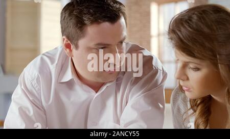Husband and wife discussing serious family issues, planning future together Stock Photo