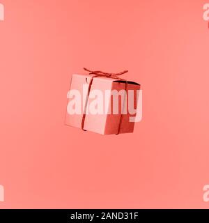 Seemless pattern of craft cardboard gift boxes on the solid pink background. Holiday and gift concept. Pop art slyle. Square. Living coral theme - color of the year 2019 Stock Photo