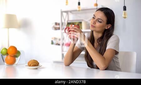 Beautiful female enjoying morning coffee, nice beginning of day, relaxation Stock Photo