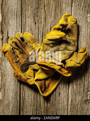 Studio still life close-up of worn leather work gloves Stock Photo