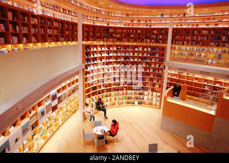 An inside view of citizens reading and strolling in the praised most beautiful Xinhua Bookstore designed by Japanese self-taught architect in Minhang Stock Photo