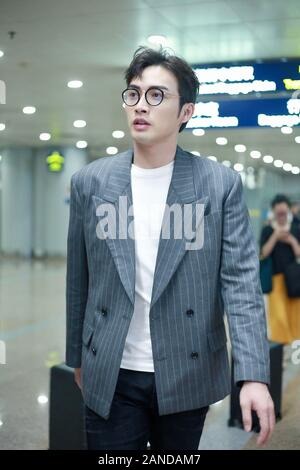 --FILE--Chinese actor Zhang Binbin, also known as Vin Zhang, talks with his companions at an airport in Beijing, Chinese, 19 July 2019. *** Local Capt Stock Photo