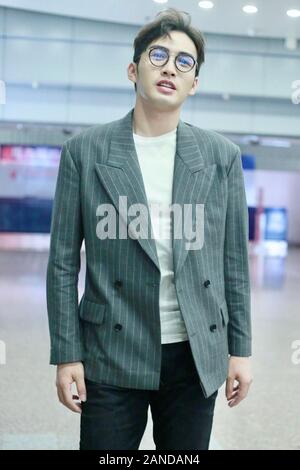 --FILE--Chinese actor Zhang Binbin, also known as Vin Zhang, talks with his companions at an airport in Beijing, Chinese, 19 July 2019. *** Local Capt Stock Photo