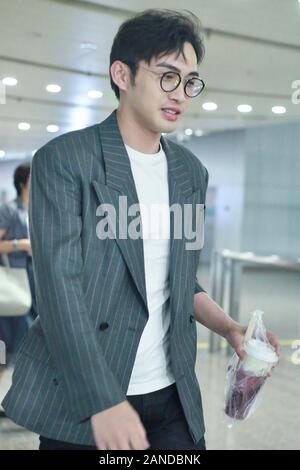 --FILE--Chinese actor Zhang Binbin, also known as Vin Zhang, talks with his companions at an airport in Beijing, Chinese, 19 July 2019. *** Local Capt Stock Photo