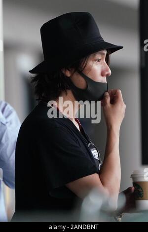 --FILE--Chinese actor Chen Kun, also knowns as Aloys Chen, shows up with a cup of coffee at an airport in Beijing, China, 30 May 2019. *** Local Capti Stock Photo