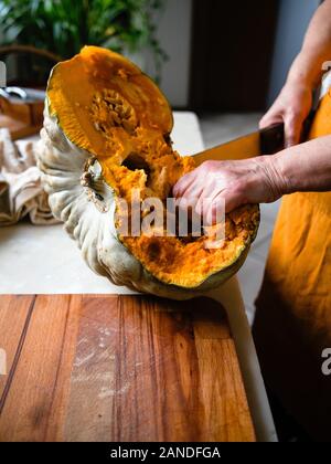 Preparing and cutting a fresh bio pumpkin Stock Photo