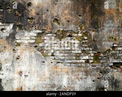 Grunge brickwork wall texture with moss render and bullet holes Stock Photo