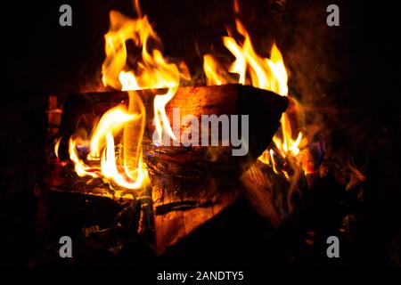 a log burning in a charmin fireplace Stock Photo