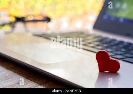 Red heart on computer keyboard soft bokeh. Internet dating, Valentines day concept with copyspace. Stock Photo