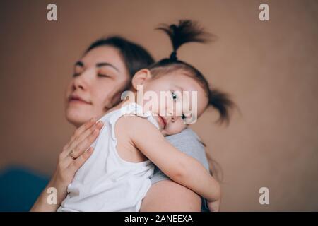 Young mother holding her little child girl. Stock Photo