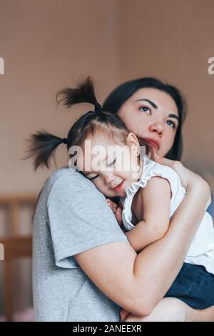 Young mother holding her little child girl. Stock Photo