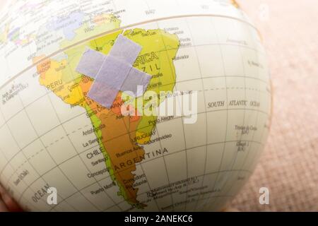 Adhesive plaster on an Earth globe in the view Stock Photo