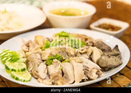 Stream chicken with white rice and soup and dipping sauce 0n the table. Selective focus. Stock Photo