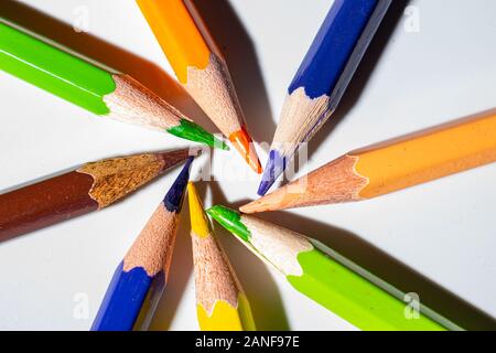 Different colors of pencils, in a spiral pattern. Colored crayons arranged in a meaningful way. Stock Photo