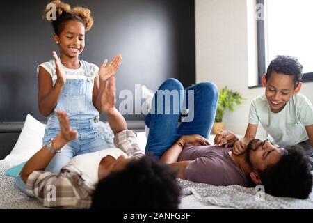 Happy african family enjoying spending time together at home. Stock Photo