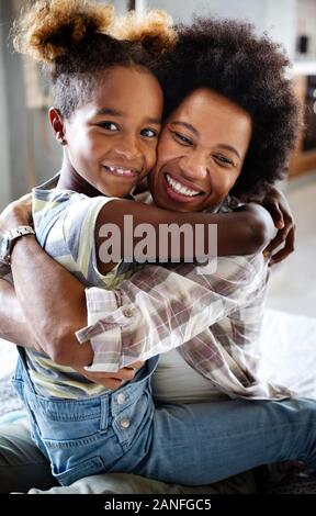 Portrait of a joyful mother and her daughter smiling and hugging Stock Photo