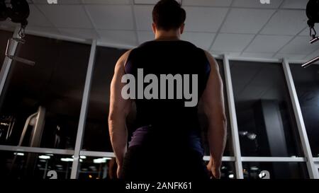 Bodybuilder relaxing after chest muscles workout on cable machine at the gym Stock Photo