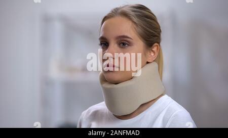 Woman in foam cervical collar, health insurance, accident victim, medical clinic Stock Photo