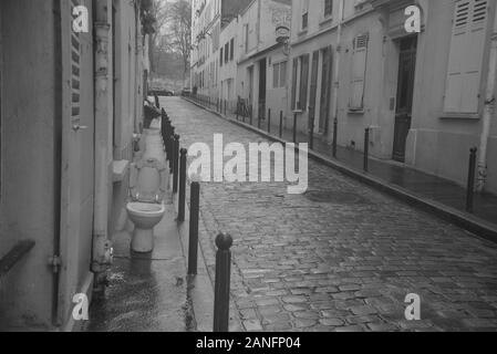 View of a quiet cobbled street in Paris with an outside lavatory, by pasakdek Stock Photo