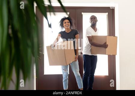 Excited black couple impressed entering new home together Stock Photo