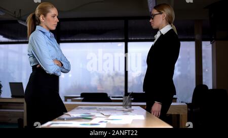 Opponents looking at each other, standing in office, business rivalry concept Stock Photo