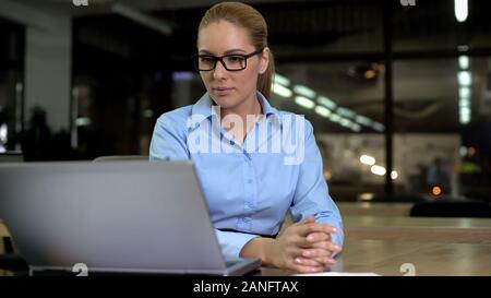 Confident employer studying information on laptop, successful female boss Stock Photo