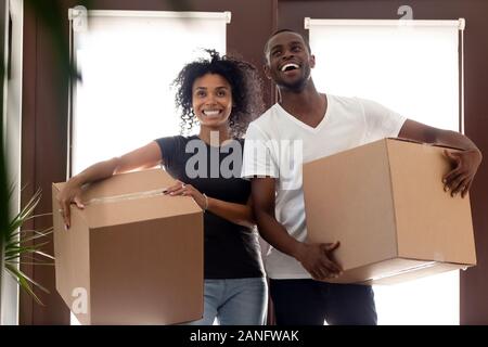 Impressed black couple entering new home on moving day Stock Photo