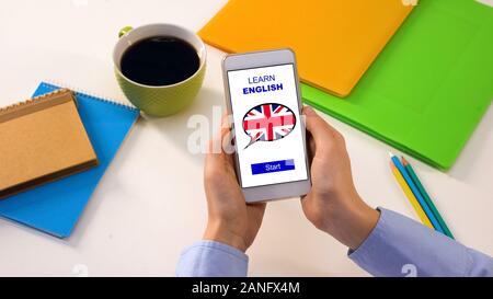 Student holding cellphone with learn English app, online education, language Stock Photo