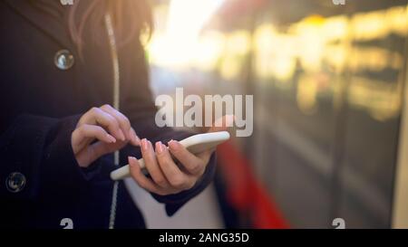 Woman checking destination point on phone, using online maps for navigation Stock Photo