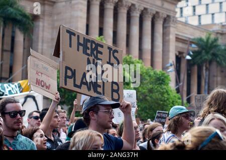 Brisbane, Queensland, Australia - 10th January 2020 : A man holds a sign protesting government inaction during a rally for climate change action in re Stock Photo