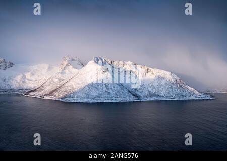 Snow mountain in blizzard on arctic circle at sunrise. Senja Islands, Norway Stock Photo