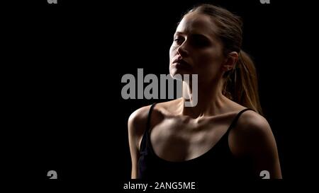 Determined lady ready to fight for women rights standing against dark background Stock Photo