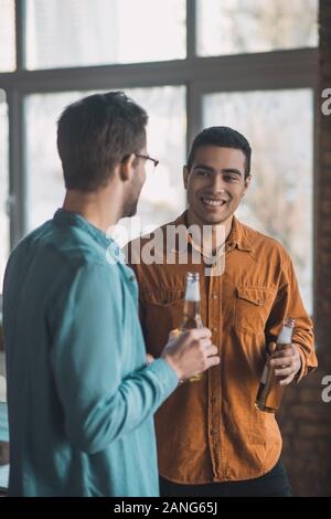 Positive young men having a pleasant conversation Stock Photo
