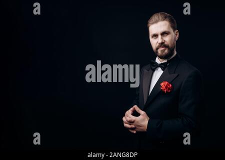 Half-turned Man in a Dinner Suit, Carnation in Buttonhole Stock Photo