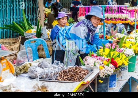 Nan, Thailand - December 16th 2014: Flower stall vendors on the market. A market is held every day in the town centre. Stock Photo