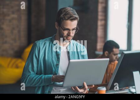 Nice good looking man working on his laptop Stock Photo
