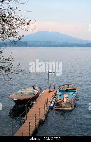 Two moored classic vintage speedboats on a private jetty in the Italian Lakes - Lake Maggiore, Piedmont, Italy EU. Stock Photo