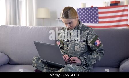 Young female soldier working with laptop in headquarters building Stock ...