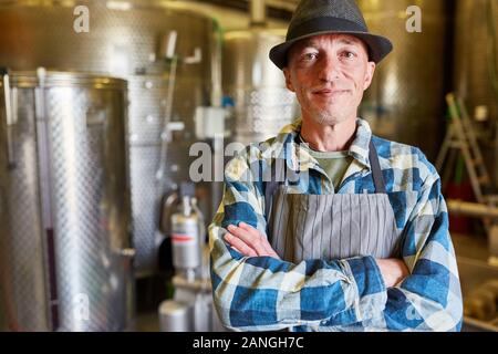 Confident winemaker or brewer in a wine cellar or brewery Stock Photo