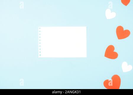 Delicate blue background with red and white hearts. Valentine's day greeting card Stock Photo