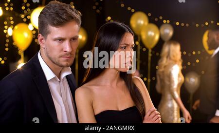 Couple ignoring each other in night club, conflict based on jealousy, betrayal Stock Photo