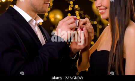 Lady taking diamond ring from boyfriend at party, accepting proposal, engagement Stock Photo